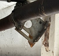 Torsion springs ripping out of spring pad